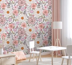 a living room with pink flowers on the wall and white chairs in front of it