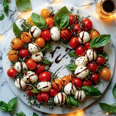 a white plate topped with tomatoes and mozzarella