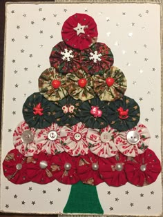 a christmas tree made out of fabric and buttons on a white card with stars around it