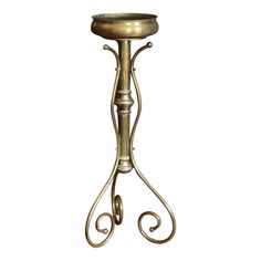 an ornate metal candle holder with two candles on the top and one in the middle