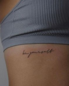 a woman's stomach with the word happiness written on it, in cursive font