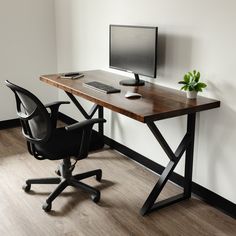 an office desk with a computer monitor, keyboard and mouse sitting on top of it