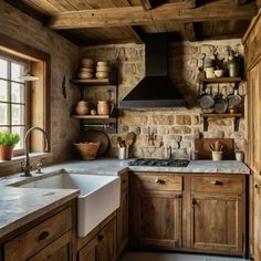 a kitchen filled with lots of wooden cabinets and counter top space next to a window