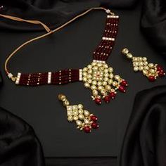 Gold Rodium Polish Red and Maroon color Necklace in Metal Alloy studded with CZ Diamond, Pearl Red Kundan Jewelry For Party, Red Jewelry Sets For Celebration, Red Metal Choker Jewelry, Red Kundan Necklace For Party, Red Kundan Choker For Gift, Red Kundan Choker As A Gift, Red Choker Jewelry Sets For Festivals, Red Kundan Choker Jewelry, Red Kundan Choker Necklace