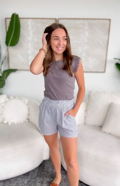 Introducing our Masion Grey Striped Elastic Waist Shorts, a stylish and versatile addition to your summer wardrobe! Crafted from lightweight and breathable fabric. Featuring a classic grey and ivory striped pattern, these shorts exude timeless charm and sophistication. Pair with a basic tee or tank top for a laid-back yet chic look! 100% Cotton Runs true to size, model wearing size Small Fabric has no stretch Lightweight Elastic waistband Pockets Inseam: 3" Patterns may vary Colors may vary from Classic Grey, Grey Tank Top, Gray Tank, Elastic Waist Shorts, Grey Top, Basic Tee, Sleeve Detail, Grey Stripes, Stretchy Fabric