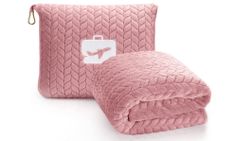 a pink blanket and pillow set on a white background