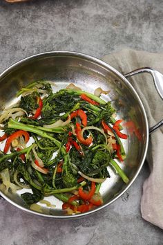 a pan filled with vegetables on top of a table