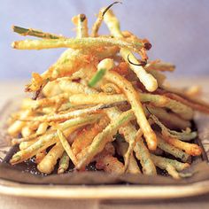 a pile of french fries sitting on top of a plate