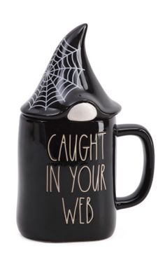 a black coffee mug with the words caught in your web on it's side