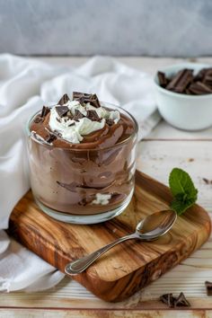 a dessert in a glass with whipped cream and chocolate