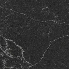 black marble with white swirls and dots on the surface is seen here in this image