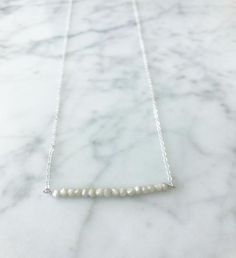 The London Bar White Silverite aNecklace / 14K Gold Fill Chain | A Blonde and Her Bag A 16" necklace of either 14K GF chain or a Sterling silver chain with 15" semi- precious stones in a row, and crystal accents at the clasp 3" Extender makes necklace 16"-19" | 1-800-Flowers Birthday Delivery The London Bar White Silverite Necklace - Silver Dainty Pearl Necklace For Everyday, Everyday Sterling Silver Pearl Chain Necklace, Minimalist Single Strand Necklace For Anniversary, Everyday Sterling Silver Single Strand Necklace, Everyday Single Strand Sterling Silver Necklace, 16 Necklace, Flowers Birthday, London Bars, The London