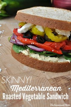 a close up of a sandwich on a cutting board with the words skinnyy mediterranean roasted vegetable sandwich