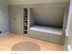 a room with a bed, bookshelf and cupboards in the middle of it