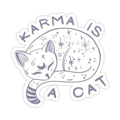 a white sticker with the words karma is a cat on it's back