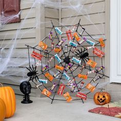 an outdoor halloween decoration with candy bars and spider web