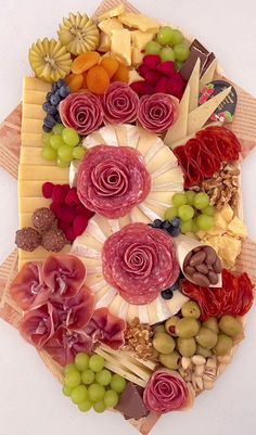 an assortment of cheeses, meats and vegetables arranged in a circular arrangement