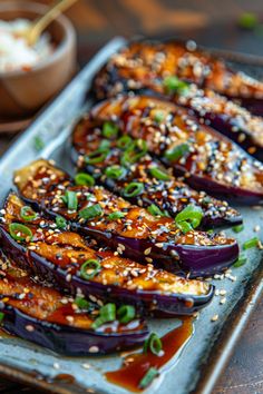 Roasted eggplant topped with sesame seeds, chopped green onions, and a savory sauce on a ceramic plate. Miso Glazed Aubergine, Japanese Veggie Side Dish, Japanese Side Salad, Eggplant Balsamic Recipes, Miso Eggplant Japanese, Japanese Vegetable Dishes, Purple Salad Recipes, Oi Muchim Recipe, Miso Glazed Eggplant Recipe