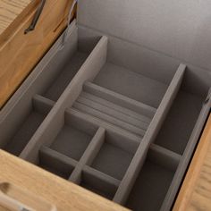 an open drawer with several compartments in it