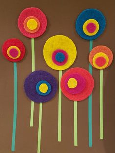 paper flowers are arranged on a brown surface