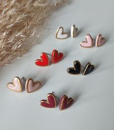 These Shiny Heart Shaped Stud earrings are simply beautiful and they are perfect for everyday. The size is approximately 14mm x 12mm And they feature a shiny resin finish surrounded by a gold coloured metal frame. Choose from 6 colours: Black Red Burgundy Dusty Pink Pastel Pink Natural  Choose from gold or silver frame. These Shiny Heart shaped stud earrings are handmade with a lot of love using lightweight polymer clay so they are very comfortable and lightweight to wear.  The metal fixings are Everyday Stud Earrings, Earrings Handmade Clay, Everyday Earrings Studs, Handmade Clay Earrings, Earrings Everyday, Rose Pastel, Heart Stud Earrings, Handmade Clay, Earrings Stud