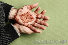 a person's hand with henna painted on it