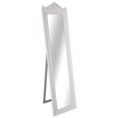 a white floor mirror sitting on top of a table