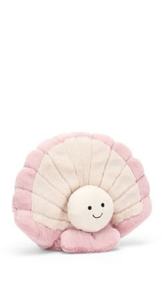 a small stuffed animal with a pink shell on it's back, sitting in front of a white background