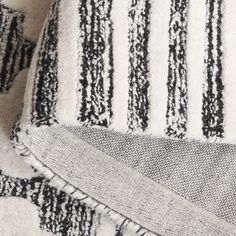 black and white striped rug with fringes on it's edges, close up