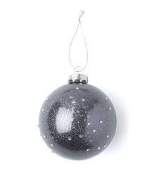 a black and white ornament hanging from a string on a white background with snow flakes