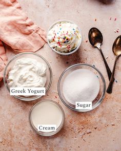 three bowls filled with whipped cream and two spoons