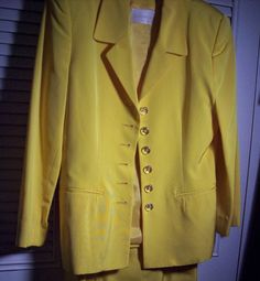 "Dana Buchman stunning yellow skirt suit. Shown with a silk Carlisle blouse which just happens to match the suit perfectly. I haven't listed the blouse yet as if the buyer of this suit would like it I will just include it at no additional charge. Jacket measures 38\" in the bust, length 26\". Waist on skirt measures 26\", hip 34\", length 20\". The blouse is a size 8 , bust 38\", length 20\". The fabric of the suit is acetate and cotton. No flaws of any kind. Stored with TLC. Comes from a smoke- Yellow Silk Sets For Spring, Formal Summer Sets With Buttons, Elegant Tailored Yellow Sets, Elegant Yellow Summer Sets, Classic Fitted Yellow Sets, Classic Yellow Fitted Sets, Tailored Skirt Suit For Formal Summer Events, Tailored Skirt Suit For Summer Formal Events, Vintage Formal Summer Sets