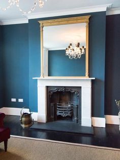 a living room with blue walls and a fireplace