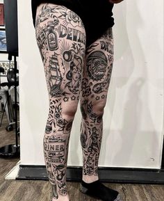 a woman with tattoos on her legs and leggings