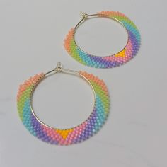 These colorful, neon pastel gold-filled hoops are handmade with love by me, lightweight and made with Miyuki Delica tiny glass beads woven with durable Fireline thread.  MATERIALS & DIMENSIONS:  🎨Hoops: 35mm dainty gold-filled hoops  🎨Beads: Miyuki Delica 2mm glass beads  🎨Thread: FireLine woven thread 🎨Rubber earring backs are included * Gold filled is the best alternative to solid gold. Please be aware that it is not solid gold and therefore can still tarnish. Please treat it with care as Hoop Beaded Earrings With Spacer Beads, Festival Small Hoop Jewelry With Tiny Beads, Festival Hoop Earrings With Tiny Beads, Hoop Earrings With Tiny Round Beads For Festivals, Handmade Rainbow Round Jewelry, Handmade Round Rainbow Jewelry, Small Hoop Earrings With Tiny Beads For Festivals, Handmade Hoop Earrings For Festival, Multicolor Woven Jewelry With Round Beads