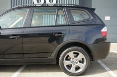 a black car parked in a parking lot with the number 60 on it's roof