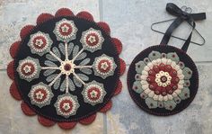 two circular rugs are sitting on the floor next to each other, one has a black ribbon around it