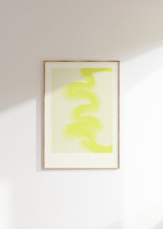 an abstract painting hangs on the wall next to a chair