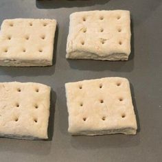 four square pieces of food sitting on top of a table