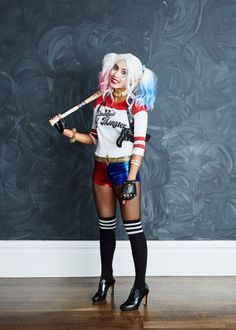 a woman dressed as harley davidson holding a baseball bat