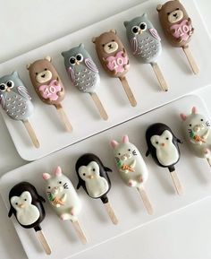 there are many cake pops decorated like animals on the skewers, and one has an owl