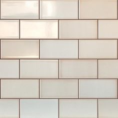 a close up view of a white tile wall