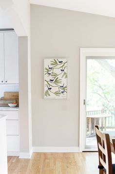 a dining room table and chairs in front of a sliding glass door