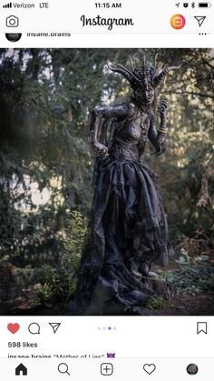 an instagramted photo of a woman dressed as a demon in the woods with trees