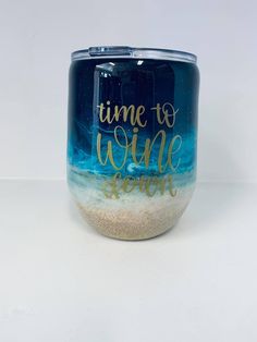 a wine glass with the words time to wine down written in gold ink on it