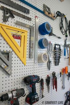 there are many tools hanging on the wall