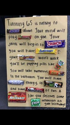 a paper sign with candy bars on it