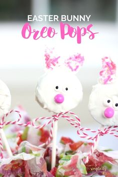 three bunny oreo pops are sitting on top of each other with pink bows around their ears