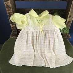 a yellow dress sitting on top of a green chair