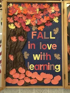 fall in love with learning bulletin board made from paper leaves and cutouts on wood frame